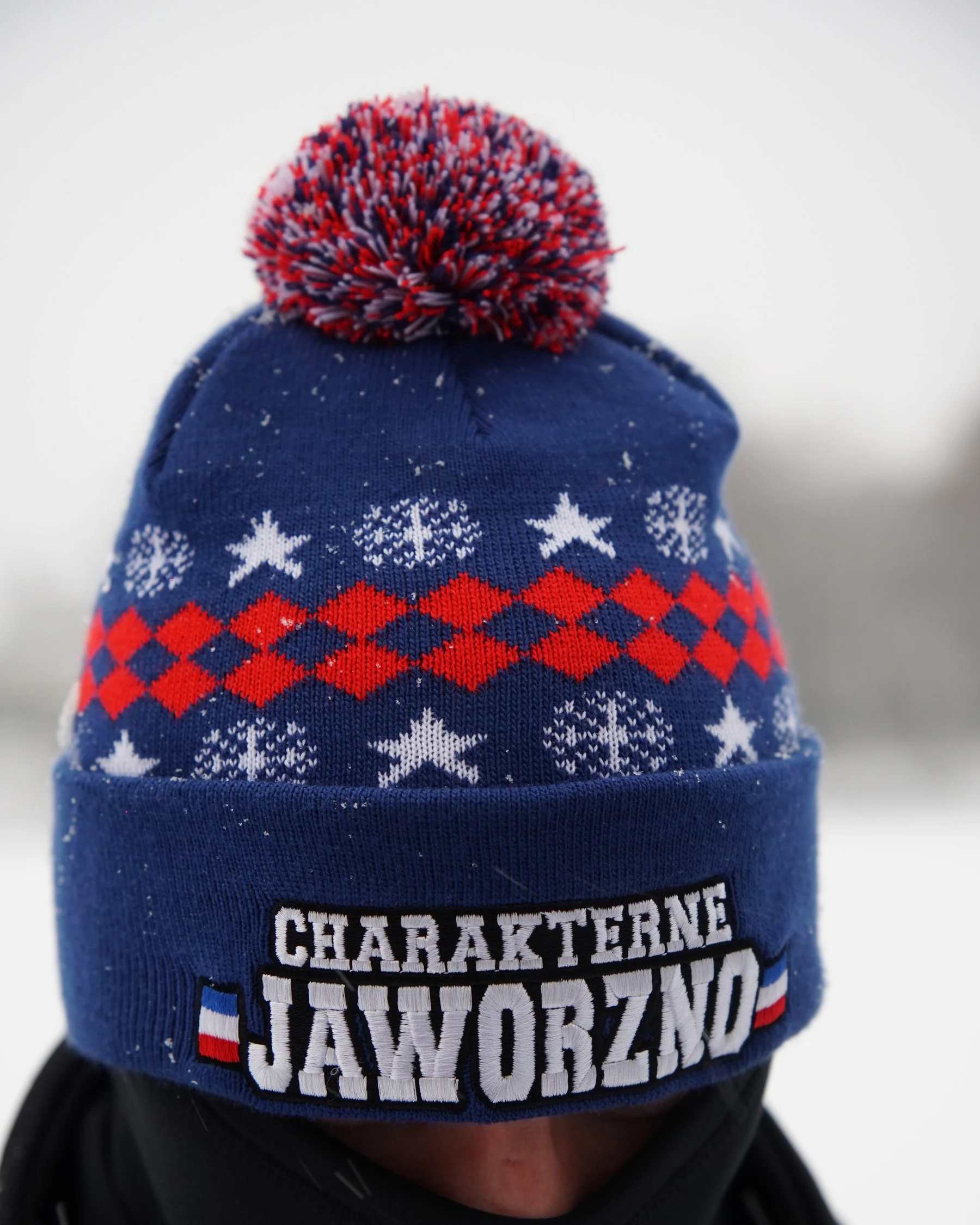 Czarno-granatowa czapka z pomponem i napisem CHARAKTERNE JAWORZNO na otoku